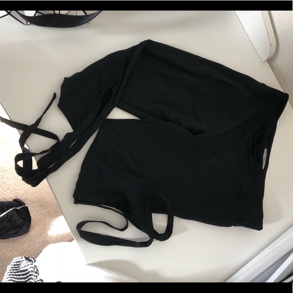 Yoga pants with leg wrap around strap