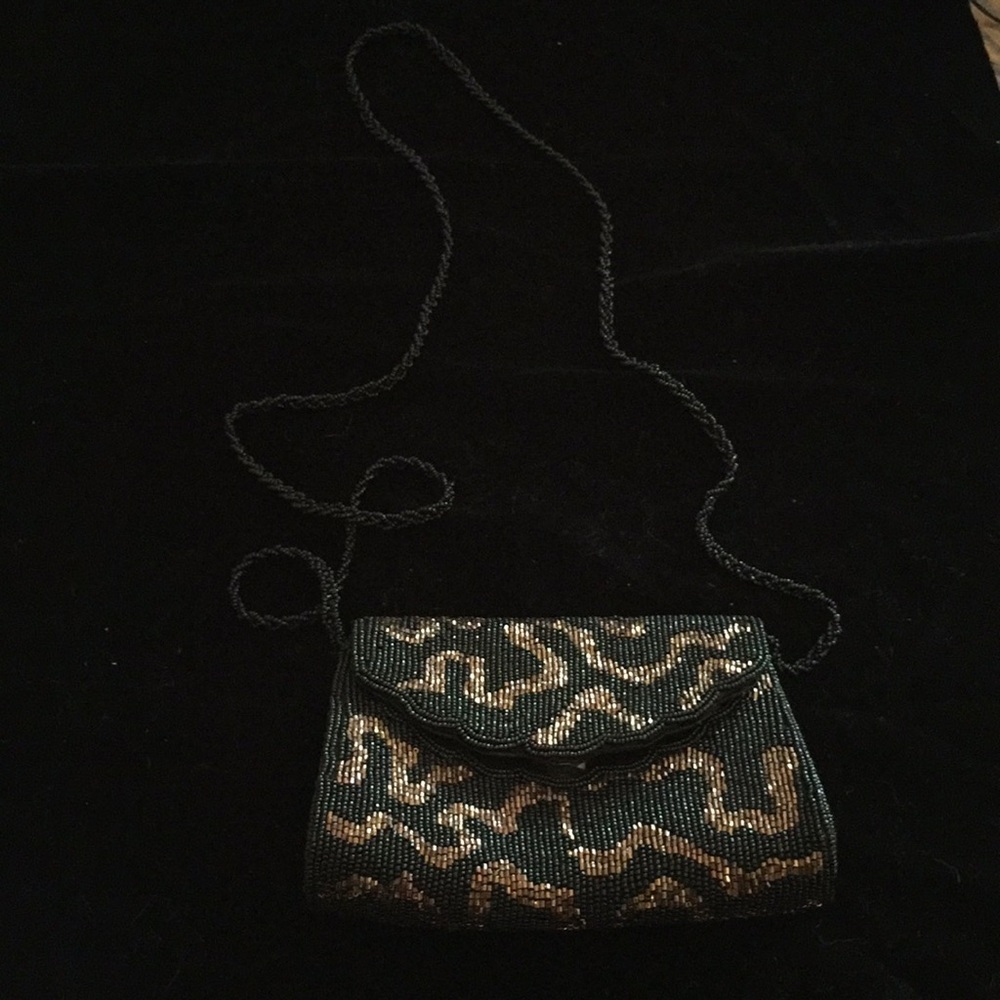 Beaded handbag with beaded shoulder strap.