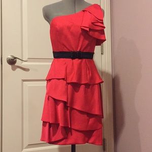 Red one shoulder ruffled dress with black belt.