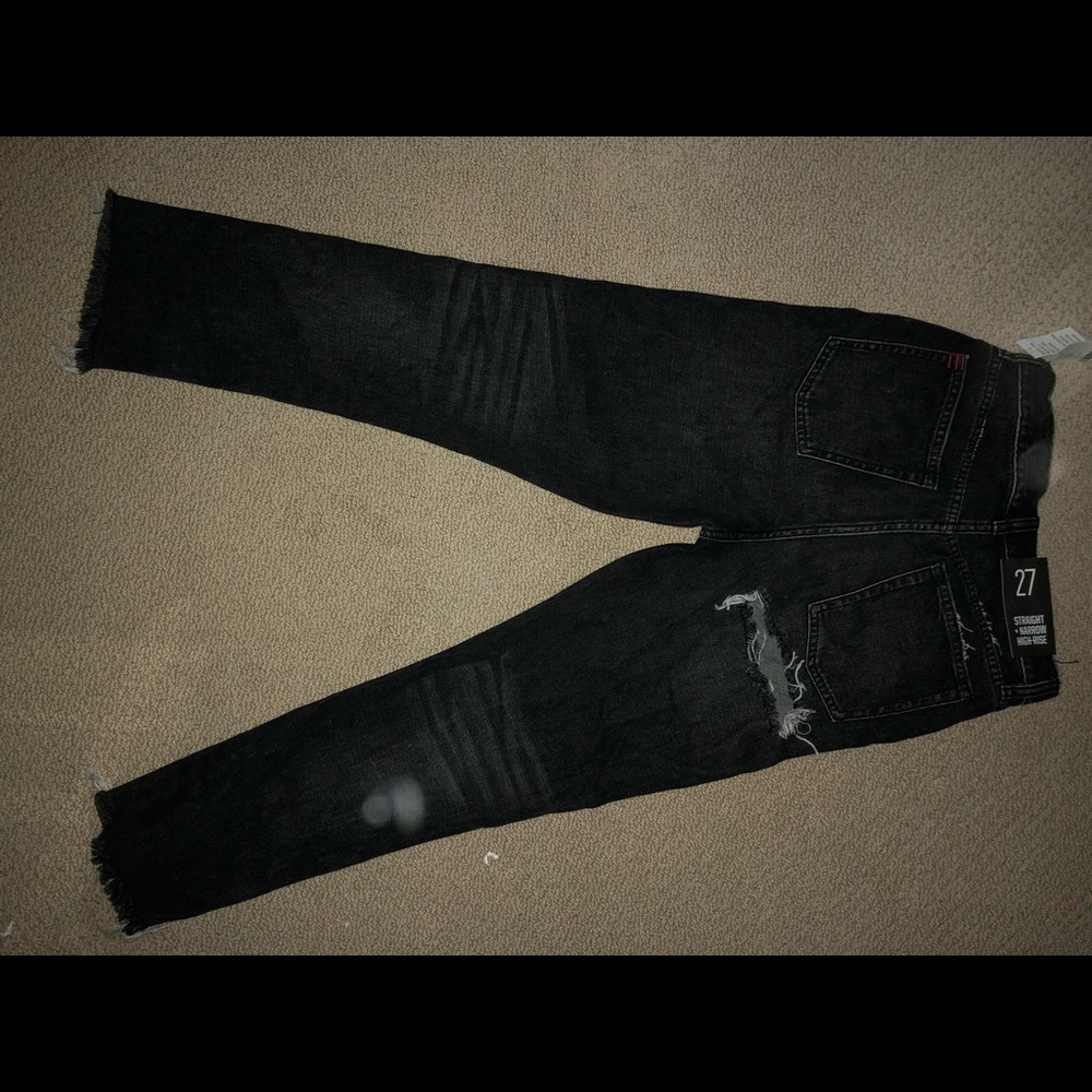 Black wide cut jeans with a rip on the butt