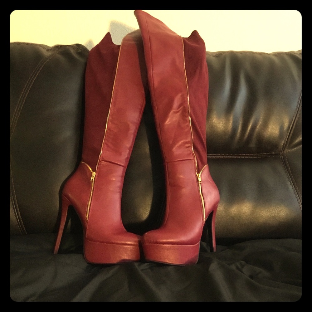 Burgundy/maroon colored above the knee boots