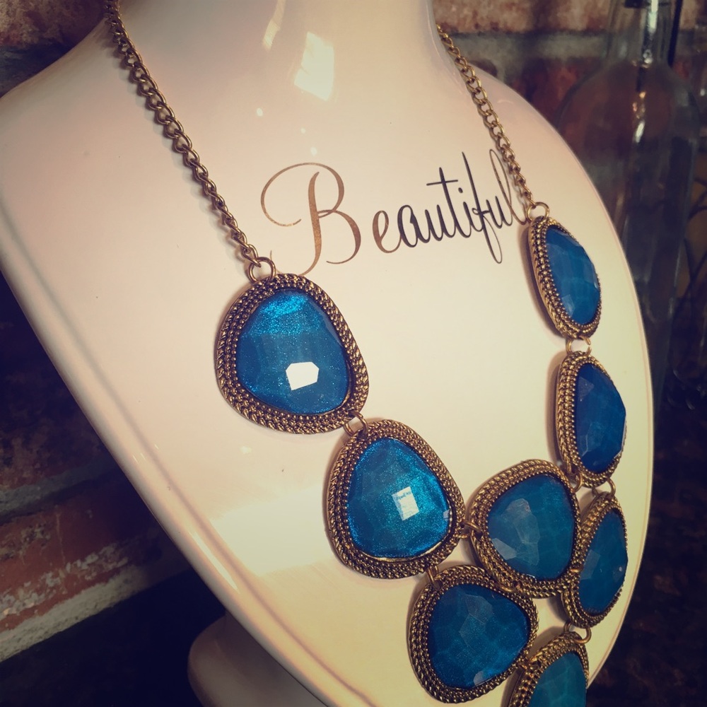 Gold tone statement necklace with blue gems