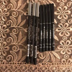 Eight black eyeliner pencils