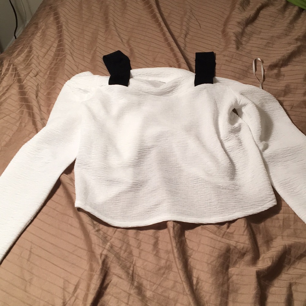 White shirt. Black straps