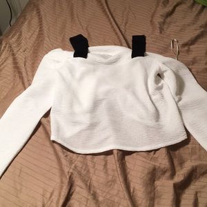 White shirt. Black straps