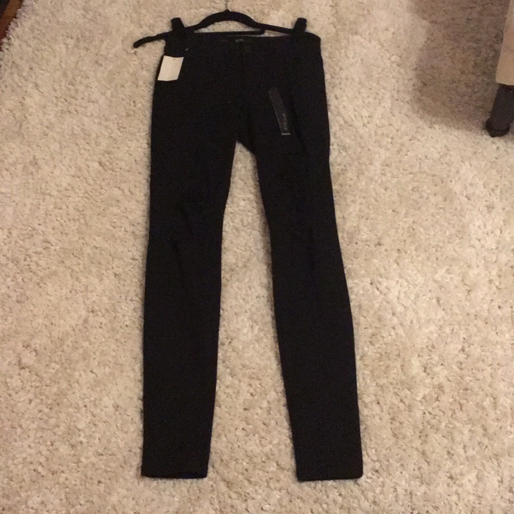 Skinny black jeans with rips in thighs