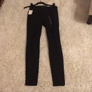 Skinny black jeans with rips in thighs