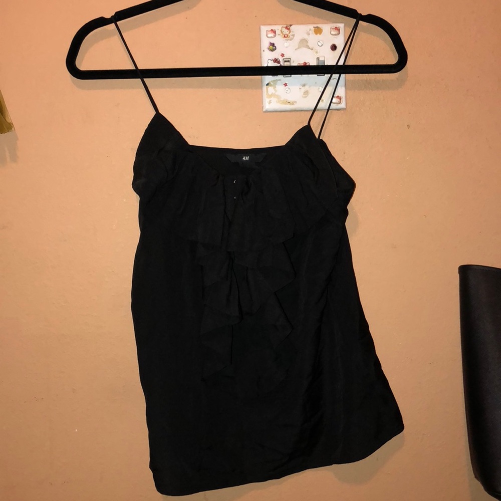 Black top with ruffles in front!