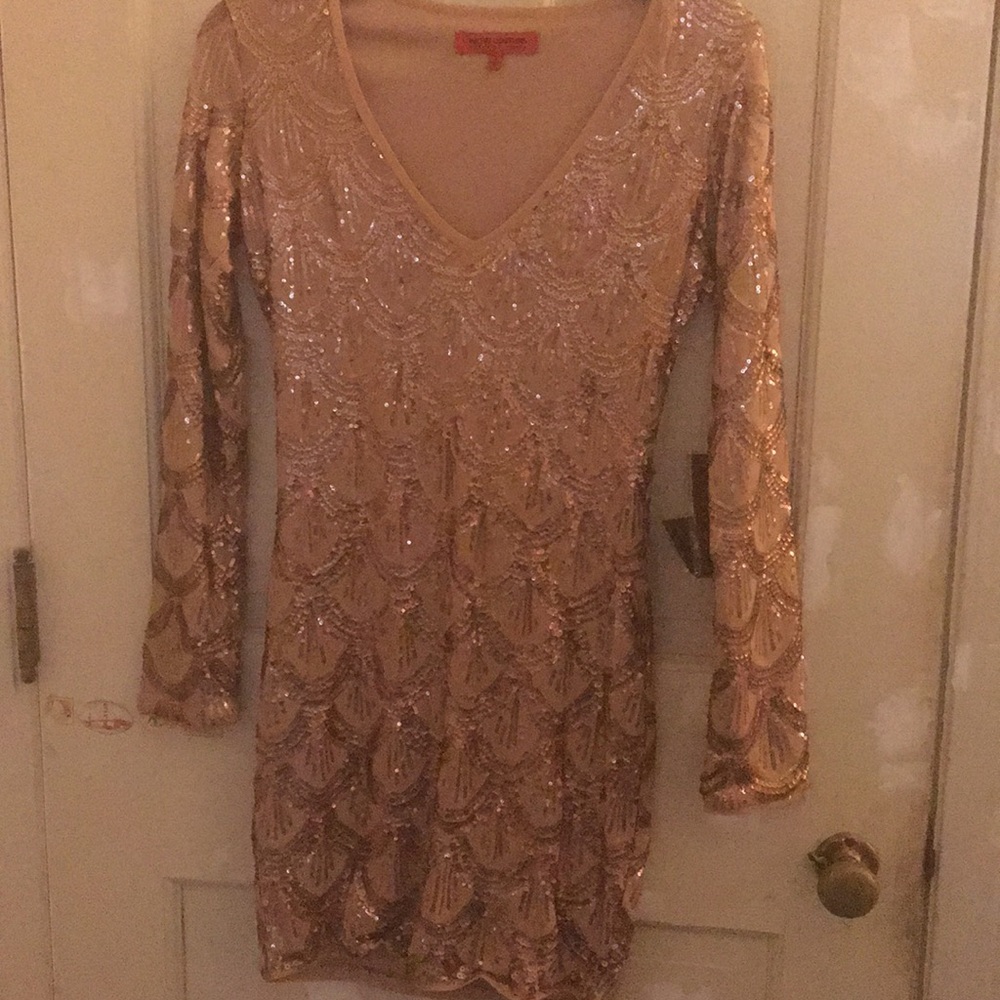 A rose gold sequin long sleeve dress