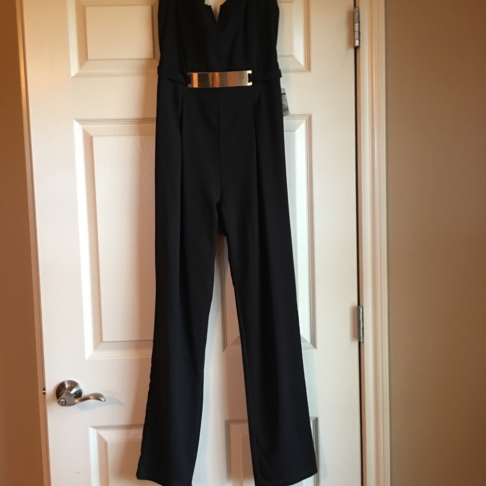 black jumpsuit with gold belt