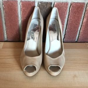 Used Michael Kor’s nude peep toe pumps