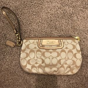 Coach wristlet/clutch in the signature pattern.