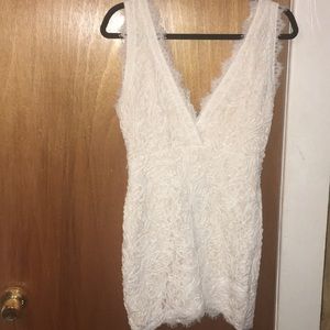 Short White cloth embroidered sleeveless dress.