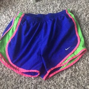blue, green, and pink Nike shorts