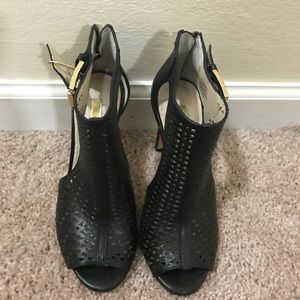 Perforated peep toe black leather heels....