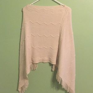 Tan poncho. Fringe.