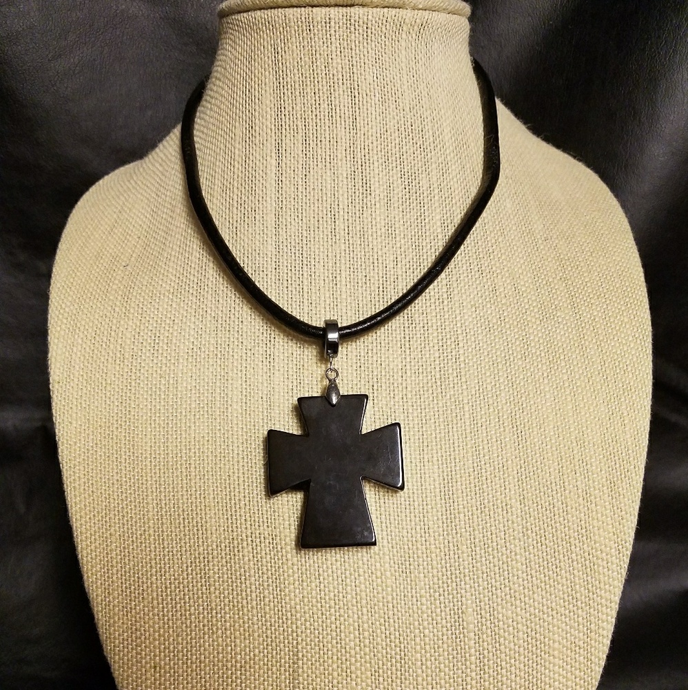 Black cross on a leather necklace.