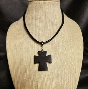 Black cross on a leather necklace.