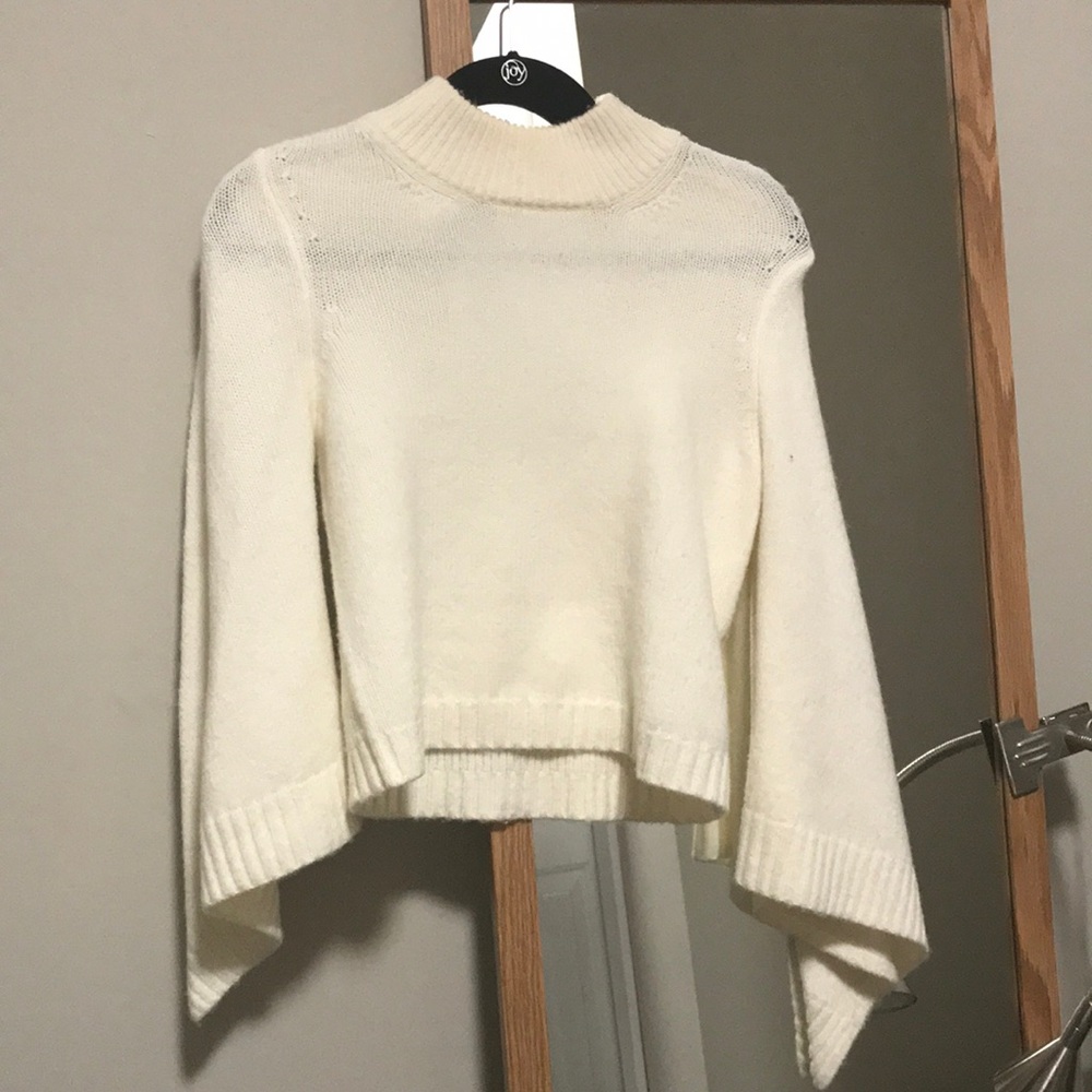 White turtleneck sweater with flared sleeves