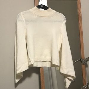 White turtleneck sweater with flared sleeves