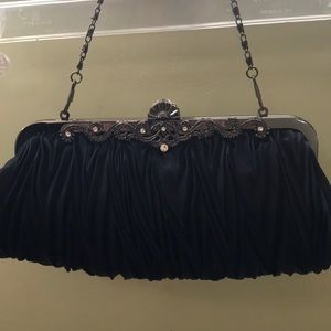 Navy blue clutch bag with silver strap