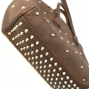 Gold studs on brown handbag with removable strap
