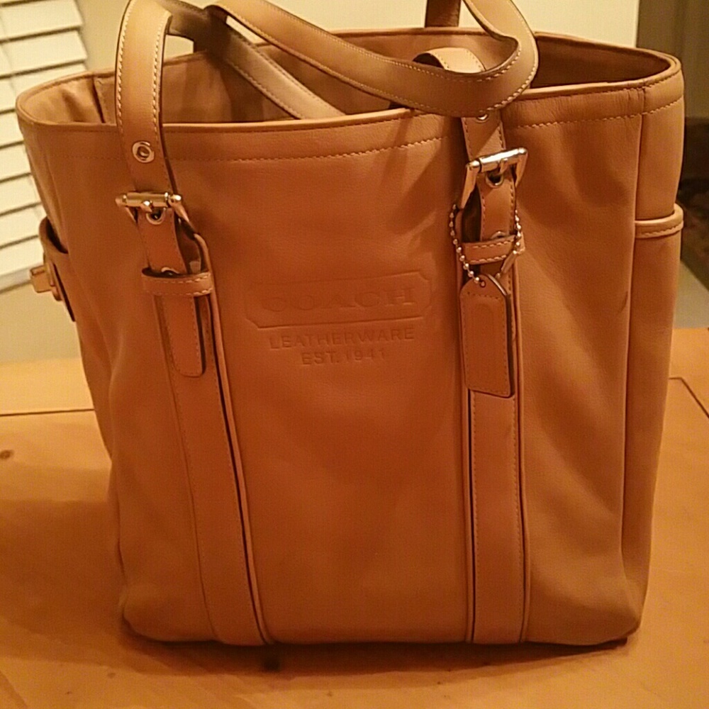 Tan leather coach bag.