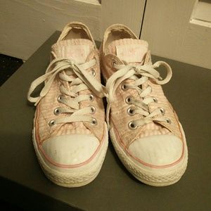 Pink and white converse shoes
