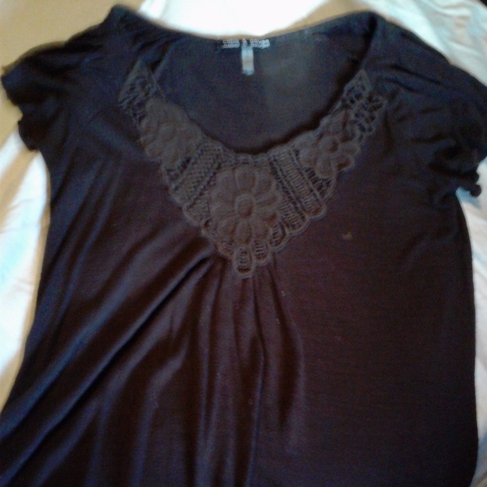 Cute purple v neck shirt with design on front.