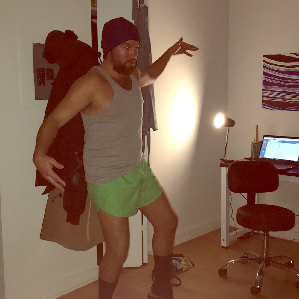 Neon green boxers, gray tank, dress socks, slippys