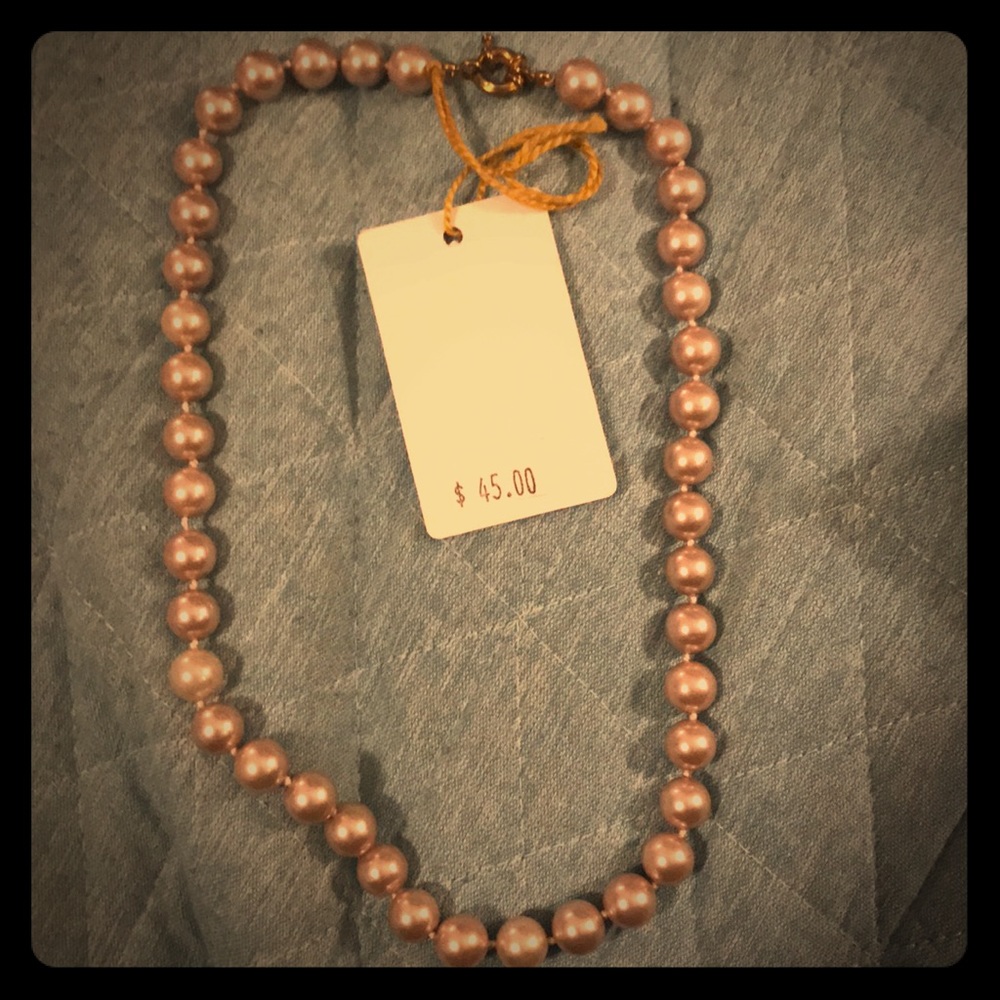 A pearl necklace . Off pink